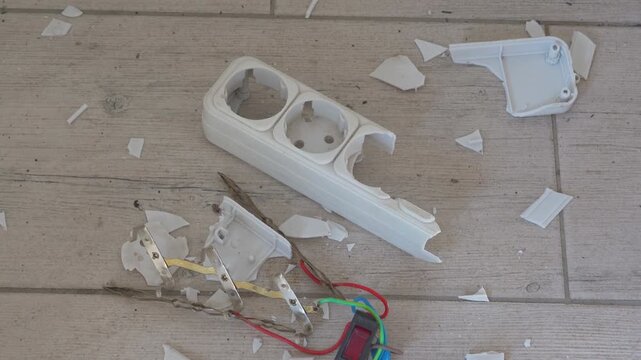 Damaged power strip housing, Extension cord with a smashed outlet