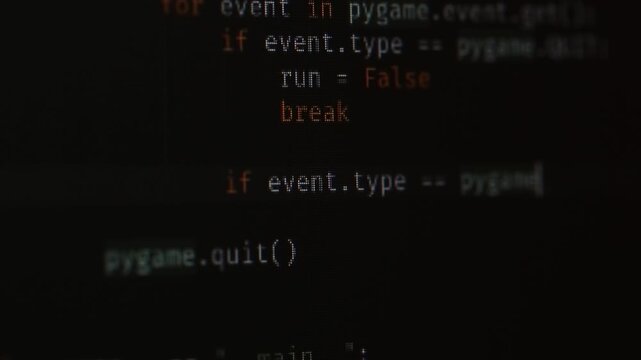 The program code on the monitor screen is close, the programmer is writing the code