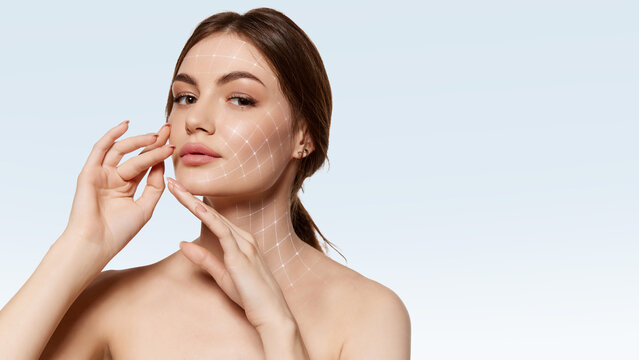 Modern poster woman portrait touching face with facial grid overlay. Concept of personalized skincare program visualization, cosmetic assessment service and medspa branding content.