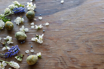 Easter flat lay. Stylish easter eggs and spring flowers and cherry blossoms on rustic wooden background. Easter celebration, season greetings. space for text © sonyachny