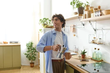Selbstklebende Fototapeten Altes Krankenhaus Beelitz Young man with curly hair enjoys a peaceful morning at home with coffee  © LIGHTFIELD STUDIOS