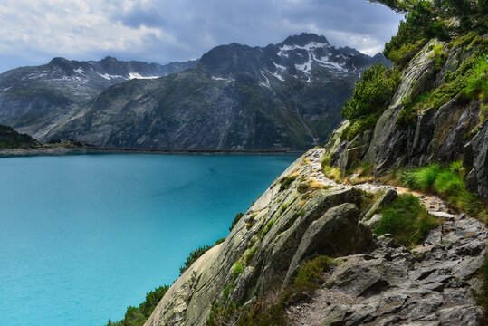 Hiking path along a mountainside by Lake Gelmer (Gelmersee), Bernese Oberland, Switzerland