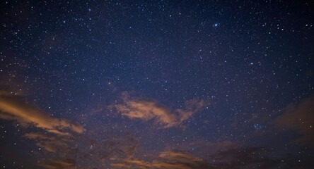 Fototapeta premium Sparkling starry night sky mingled with soft cloud layers