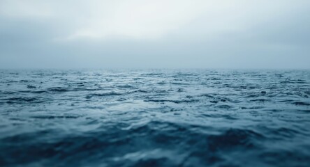 Fototapeta premium Blue water surface bubbling naturally as it meets a cloudy horizon scene