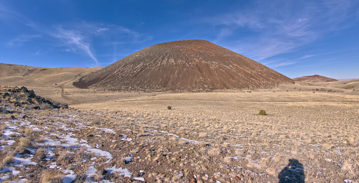 Shadow of a man taking a photo of the southeast Slope of SP Crater near Flagstaff, Arizona, USA