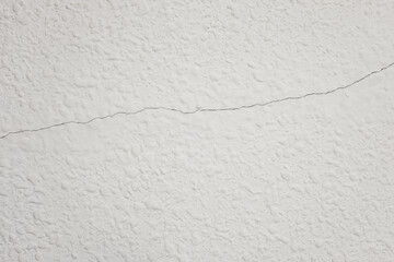 White textured wall having a horizontal crack line © DavidIgSu