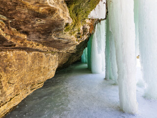 Pathway between ice columns and rock cliff in the Portneuf Natural Regional Park, a popular winter attraction in Saint-Alban, Qu&eacute;bec, Canada