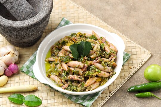 Authentic Indonesian sambal cumi asin lombok ijo, a traditional spicy salted squid dish cooked with green chili peppers, shallots, and aromatic spices.