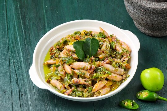 Authentic Indonesian sambal cumi asin lombok ijo, a traditional spicy salted squid dish cooked with green chili peppers, shallots, and aromatic spices.