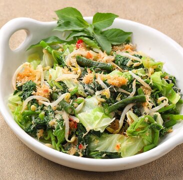 Urap Sayur is Indonesian traditional food. a salad dish of steamed various vegetables mixed with seasoned and spiced. 
