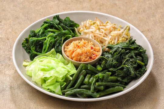 Urap Sayur is Indonesian traditional food. a salad dish of steamed various vegetables mixed with seasoned and spiced. 
