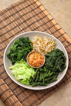 Urap Sayur is Indonesian traditional food. a salad dish of steamed various vegetables mixed with seasoned and spiced. 
