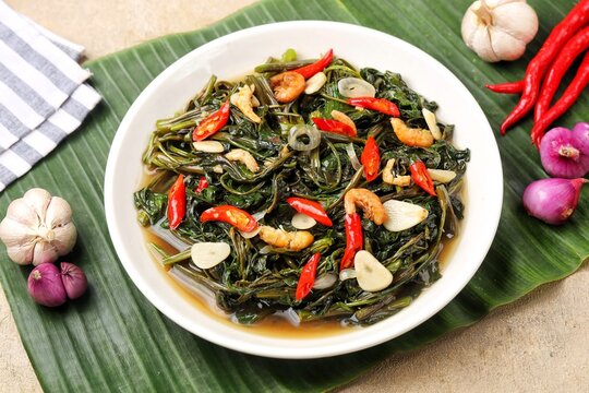 Tumis Kangkung, kangkung goreng belacan or belacan kangkung. Stir-fried water spinach is a typical Asian vegetable dish, known by various names in various Asian languages. 