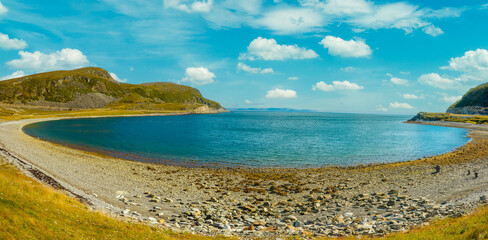 Rocky beach, beautiful arctic bay, mountain landscape with blue sky and sea, Trolls from pebbles. Wild nature Norway, seascape. © vvvita