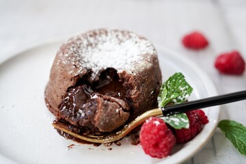 Homemade Chocolate molten lava cake served with raspberries and powdered sugar © vm2002