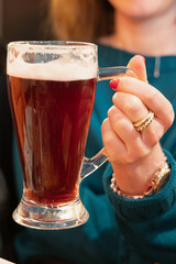 Amber beer closeup. Close view of drinker with rings and pub ambiance