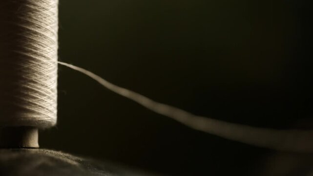 A skein of white thread on a sewing machine