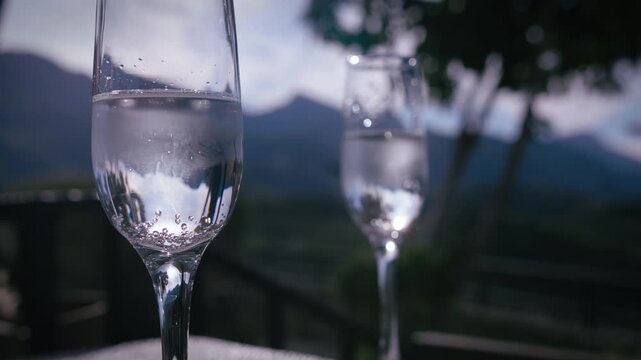 Chilled Champagne Served in Elegant Glasses on Outdoor Terrace with Mountain Landscape View