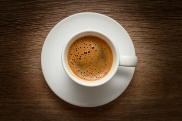 Fototapeta premium Top view of Turkish coffee cup on wooden table
