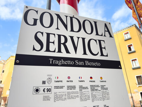 Venice, Italy - February 10, 2026: Gondola service sign displaying rates and information for Traghetto San Beneto in a colorful urban setting
