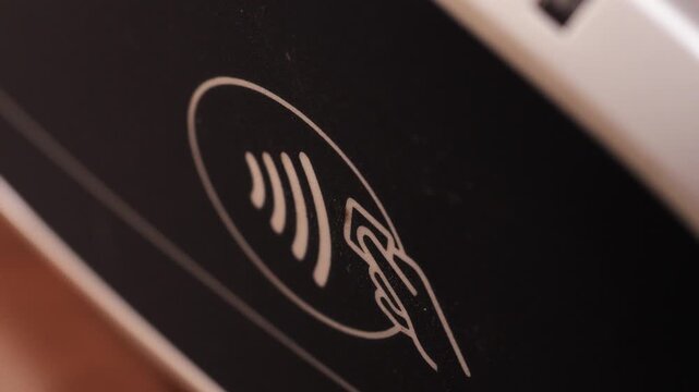 Credit card taps contactless reader and moves away after payment approval