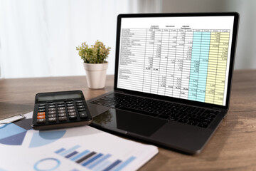 Financial report on laptop screen with calculator and business chart on desk, accounting and budgeting concept, business analysis, audit, tax planning, financial management in office