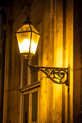 Yellow facade with a lit lantern,  Zagreb, Croatia
