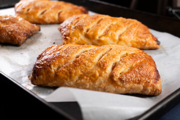 Close up of freshly baked golden crispy danish pastries with apricot filling