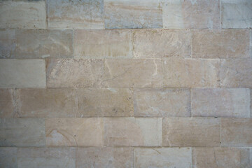 High-quality beige limestone wall texture, rectangular stone tile pattern, clean architectural background for interior and exterior design.