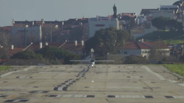 Small propeller plane taking off from concrete runway