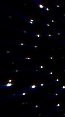 Minimalist dark background with evenly spaced bright star points emitting colorful light rays