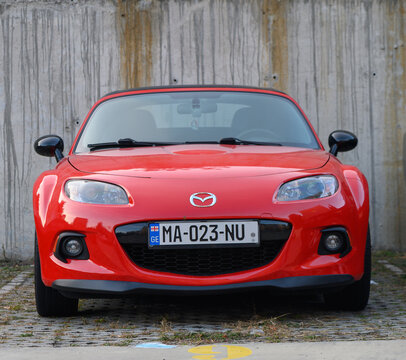 Tbilisi, Georgia, December 11, 2025 Vibrant Red Mazda MX-5 Miata Roadster Parked in City
