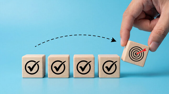Hand placing target block on checklist, achieving goals, business success, strategy, planning