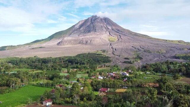 Aerial view of Mount Sinabung volcano in North Sumatra, Indonesia, showing its vast lava flows and surrounding vegetation
