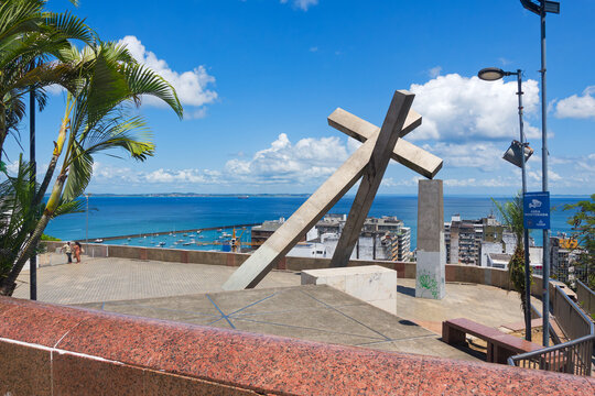 Sightseeing at the old town of Brazilian city of Salvador with fallen cross sculpture by Mario Cravo 1999 on a sunny spring day. Photo taken October 16th, Salvador, Bahia, Brazil.