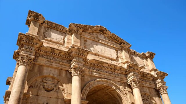 Ancient roman ruins of the arch of hadrian in jerash jordan. Magnificent architecture and stone carvings under a bright sunny sky. Historical middle east travel destination