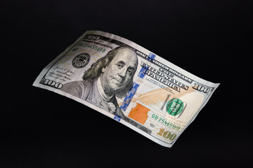 Floating 100 US Dollar Bill over Solid Black Background