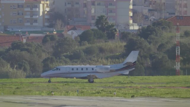 Private business jet taxiing on airport runway