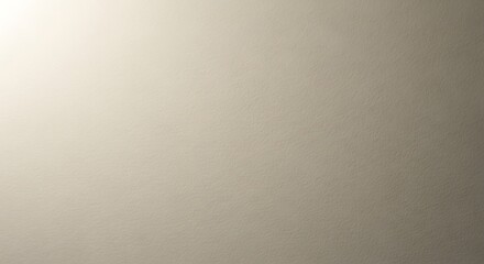 A close-up view of a beige wall with a textured surface and subtle lighting effects