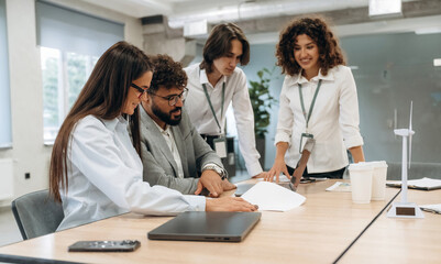 Fototapeta premium Table with laptops. Group of people are working in the office together as a team