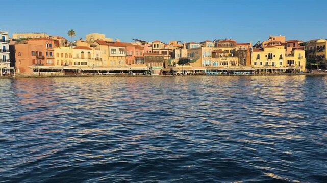 bay of Chania with sea and lighthouse at sunny summer sunset, Crete, Greece,