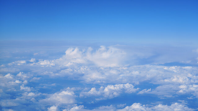 Aerial view of cloudscape under clear blue sky, tranquil atmosphere and aviation travel background.