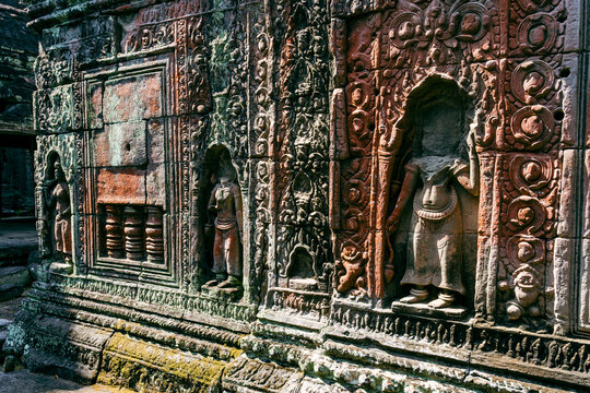 Intricate Sandstone Bas-Relief Carvings of Devata Goddesses on Ancient Khmer Temple Wall in Angkor Archaeological Park