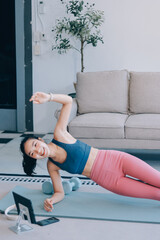 Young Asian sporty attractive people practicing yoga lesson with instructor. Asia group of women exercising healthy lifestyle in fitness studio. Sport activity, gymnastics or ballet dancing class.