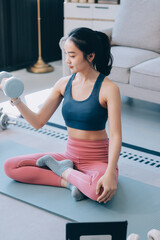 Young Asian sporty attractive people practicing yoga lesson with instructor. Asia group of women exercising healthy lifestyle in fitness studio. Sport activity, gymnastics or ballet dancing class.