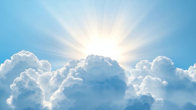 Sunlight bursts from behind fluffy cumulus clouds in a bright blue sky. Rays emanate towards the camera