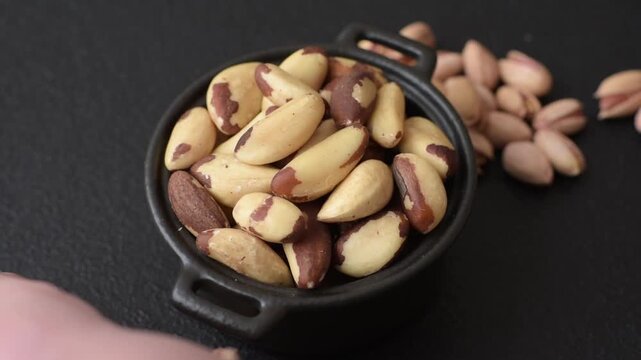 Brazil nuts, raw and shelled, are a source of selenium and a healthy food ingredient. Brazil nuts as a food background for your design