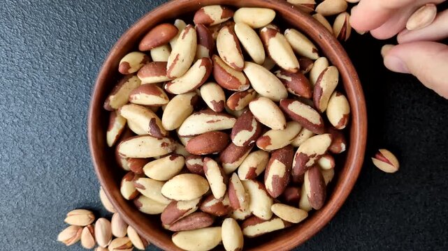 Brazil nuts, raw and shelled, are a source of selenium and a healthy food ingredient. Brazil nuts as a food background for your design