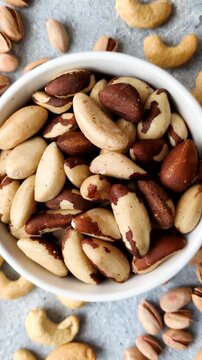 Brazil nuts, raw and shelled, are a source of selenium and a healthy food ingredient. Brazil nuts as a food background for your design
