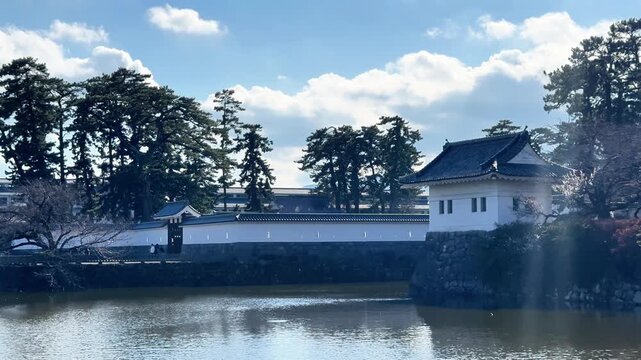 White castle wall reflected in a calm Japanese moat